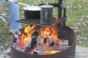 old hand me down coffee pot and christmas present popcorn popper over roaring campfire